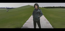Rule 34 | 1girl, absurdres, black choker, black eyes, black hair, black pants, choker, commentary request, day, faiz azhar, highres, hill, jacket, letterboxed, long sleeves, looking at viewer, original, outdoors, pants, path, road, short hair, smile, solo focus, standing