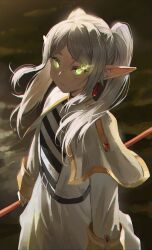 Rule 34 | 1girl, belt, capelet, closed mouth, commentary, dotthebot, drop earrings, earrings, elden ring, elf, english commentary, eyelashes, frieren, glowing, glowing eyes, gold trim, green eyes, highres, jewelry, long hair, parted bangs, pointy ears, solo, sousou no frieren, standing, thick eyebrows, twintails, white capelet, white hair