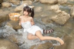 Rule 34 | 1girl, anal tail, animal ears, asian, bathing, black hair, breasts, bucket, butt plug, chinese (nationality), chunmomo0127, cleavage, closed mouth, fake animal ears, fake tail, feet, holding, holding towel, in water, lying, medium breasts, outdoors, photo (medium), real life, rock, sex toy, smile, solo, tail, towel, water