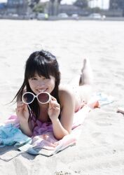 Rule 34 | 1girl, aida rikako, beach, bikini, highres, looking at viewer, outdoors, photo (medium), sand, smile, sunglasses, swimsuit, towel, voice actor