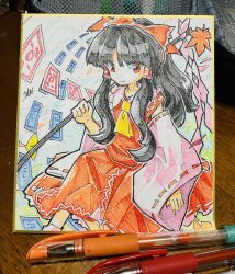 Rule 34 | 1girl, art tools in frame, autumn leaves, black hair, bow, closed mouth, commentary, danmaku, detached sleeves, doggo 1d34, feet out of frame, gohei, hair bow, hakurei reimu, hatching (texture), highres, holding, holding gohei, long hair, long sleeves, looking at viewer, mountain of faith, nontraditional miko, ofuda, pink sleeves, red bow, red eyes, red ribbon, red skirt, red vest, ribbon, ribbon-trimmed sleeves, ribbon trim, shikishi, sidelocks, skirt, skirt set, solo, touhou, traditional media, vest, wide sleeves