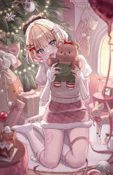 absurdres blonde_hair box christmas_tree fang full_body gift gift_box green_eyes hair_ornament highres holding holding_stuffed_toy indoors kneehighs kneeling kurumi_noah leg_tattoo looking_at_viewer multicolored_hair open_mouth pora_0918 purple_hair shirt short_hair short_sleeves skirt smile socks solo stuffed_toy tattoo virtual_youtuber vspo! white_arm_warmers white_shirt white_socks