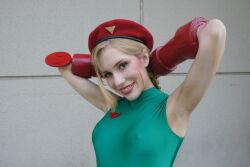 Rule 34 | 1girl, armpits, arms behind head, arms up, blonde hair, braid, breasts, cammy white, cammy white (cosplay), capcom, cosplay, covered erect nipples, crystal graziano, hat, leotard, looking at viewer, medium breasts, photo (medium), smile, street fighter