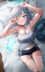 Rule 34 | 1girl, absurdres, animal ear fluff, animal ears, bed, bed sheet, black shorts, blue archive, blue eyes, blue halo, blush, breasts, camisole, cellphone, cleavage, cross hair ornament, extra ears, grey camisole, grey hair, hair ornament, halo, highres, looking at viewer, m0 0m c, medium breasts, medium hair, navel, one eye closed, open mouth, phone, pillow, shiroko (blue archive), shorts, smartphone, solo, thighhighs, white thighhighs, wolf ears