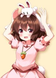 1girl :d animal animal_ears animal_on_head arms_up blush brown_hair carrot_necklace commentary dress floppy_ears highres inaba_tewi jewelry looking_at_viewer necklace on_head open_mouth pink_dress puffy_short_sleeves puffy_sleeves rabbit rabbit_ears rabbit_girl rabbit_tail red_eyes ruu_(tksymkw) short_hair short_sleeves simple_background smile solo tail touhou upper_body yellow_background