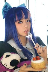 Rule 34 | 1girl, blue eyes, blue hair, blunt bangs, blurry, bow, cake, cosplay, depth of field, food, fork, hair bow, hair ornament, lolita fashion, long hair, looking at viewer, matching hair/eyes, panty &amp; stocking with garterbelt, photo (medium), solo, stocking (psg), stocking (psg) (cosplay)