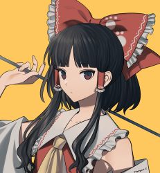 Rule 34 | 1girl, arm up, artist name, ascot, black eyes, black hair, blunt bangs, bow, closed mouth, commentary, detached sleeves, frilled bow, frilled shirt collar, frills, gohei, hair bow, hair tubes, hakurei reimu, harano, holding, looking at viewer, multicolored eyes, paw print, red bow, red eyes, shide, short hair with long locks, sidelocks, solo, swept bangs, touhou, tsurime, upper body, wily beast and weakest creature, yellow ascot, yellow background