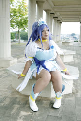 Rule 34 | 1girl, ankle boots, asian, blue eyes, blue hair, boots, bow, bracelet, breasts, choker, chouzuki maryou, cosplay, cure diamond (cosplay), dokidoki! precure, dress, headpiece, highres, jewelry, large breasts, long hair, magical girl, matching hair/eyes, photo (medium), plump, ponytail, precure, puffy short sleeves, puffy sleeves, ribbon, short sleeves, sitting, solo, tiara