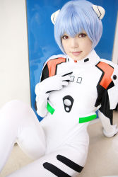 Rule 34 | 1girl, arm support, asian, ayanami rei, blue hair, color contacts, cosplay, hairpods, highres, looking at viewer, namada, neon genesis evangelion, on floor, photo (medium), plugsuit, plugsuit (cosplay), red eyes, short hair, sitting, solo