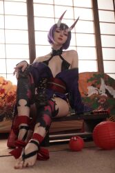 Rule 34 | 1girl, artist request, cosplay, day, fate/grand order, fate (series), feet, female focus, highres, horns, indoors, looking at viewer, photo (medium), purple eyes, purple hair, short hair, shuten douji (fate), shuten douji (fate) (cosplay), sitting, skin-covered horns, solo, toes