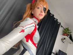 Rule 34 | 1girl, blue eyes, bodysuit, brazilian (nationality), breasts, brown hair, cosplay, evangelion: 3.0+1.0 thrice upon a time, freckles, highres, indoors, interface headset, lips, looking at viewer, looking back, memepantazis, neon genesis evangelion, photo (medium), plugsuit, rebuild of evangelion, shiny clothes, solo, souryuu asuka langley, souryuu asuka langley (cosplay), standing, twintails, two side up, white bodysuit