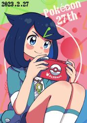 Rule 34 | 1girl, anniversary, batchgooya, blue eyes, blue hair, blush stickers, closed mouth, commentary, copyright name, creatures (company), dated, eyelashes, game freak, green jacket, hair ornament, hairclip, handheld game console, highres, holding, holding handheld game console, jacket, jewelry, liko (pokemon), medium hair, necklace, nintendo, open clothes, open jacket, pokemon, pokemon (anime), pokemon horizons, pokemon horizons, shirt, smile, socks, solo, white shirt, white socks