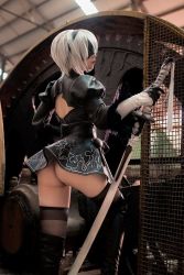 Rule 34 | 1girl, ass, black dress, black hairband, black thighhighs, blindfold, boots, closed mouth, cosplay, dress, feather-trimmed sleeves, gloves, hair over eyes, hairband, juliet sleeves, katana, long sleeves, nier, nier:automata, nier (series), panties, photo (medium), puffy sleeves, shiny clothes, short hair, skindentation, solo, sword, thigh boots, thighhighs, underwear, vambraces, weapon, white hair, white panties, 2b (nier:automata), 2b (nier:automata) (cosplay)