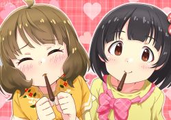 Rule 34 | 2girls, ahoge, black hair, blush, bow, brown hair, clenched hands, closed eyes, collarbone, commentary request, dannd, dress, embarrassed, floral print, food, food in mouth, heart, highres, idolmaster, idolmaster million live!, looking at viewer, multiple girls, nakatani iku, pink background, pink bow, plaid, plaid background, pocky, pocky in mouth, pocky kiss, shared food, shirt, short hair, short sleeves, smile, suou momoko, twitter username, valentine&#039;s day, wavy hair, yellow dress, yellow shirt