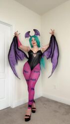 Rule 34 | 1girl, animated, ass shake, black leotard, breasts, bridal gauntlets, cleavage, cosplay, curvy, demon girl, fake wings, green eyes, green hair, hands on own hips, head wings, highleg, highleg leotard, highres, indoors, leotard, long hair, morrigan aensland, morrigan aensland (cosplay), musclemommycosplay, nail polish, pantyhose, photo (medium), purple pantyhose, real life, simple background, smile, strapless, strapless leotard, tagme, darkstalkers, video, wide hips, wings