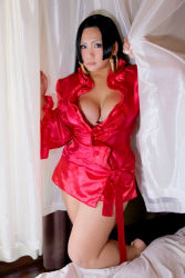 Rule 34 | 1girl, black hair, blue eyes, boa hancock, boa hancock (cosplay), breasts, chouzuki maryou, cleavage, cosplay, curtains, curvy, earrings, female focus, hip focus, jewelry, large breasts, long hair, looking at viewer, one piece, photo (medium), plump, red shirt, robe, shirt, silk robe, solo, standing, thick thighs, thighs, wide hips