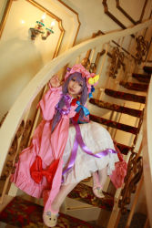 Rule 34 | 1girl, asian, cosplay, crescent, dress, female focus, hat, highres, long hair, patchouli knowledge, photo (medium), purple hair, solo, stairs, tenshi myu, touhou