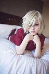 Rule 34 | 1girl, alternate costume, bed, blonde hair, blurry, blurry background, breasts, closed mouth, cosplay, female focus, hellsing, highres, large breasts, looking at viewer, lying, on stomach, photo (medium), police, police uniform, red eyes, red legwear, seras victoria, short hair, solo, stephanie fischer, tagme, uniform, vampire
