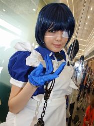 Rule 34 | 1girl, apron, asian, blue eyes, blue gloves, blue hair, collar, color contacts, cosplay, cross, cuffs, dutch angle, eyepatch, gloves, handcuffs, ikkitousen, indoors, looking at viewer, maid, maid apron, namada, photo (medium), puffy short sleeves, puffy sleeves, reflection, ryomou shimei, ryomou shimei (cosplay), short sleeves, solo, standing