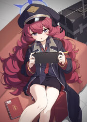 Rule 34 | 1girl, absurdres, black coat, black hat, black shirt, blue archive, blue halo, blush, book, coat, collared shirt, feet out of frame, grey eyes, hair between eyes, halo, handheld game console, hat, highres, holding, holding handheld game console, indoors, iroha (blue archive), long hair, natsuki (gedo), necktie, open clothes, open coat, open mouth, peaked cap, playing games, red hair, red necktie, shirt, solo
