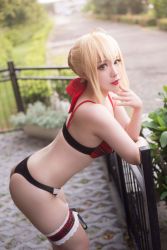 Rule 34 | 1girl, artist request, artoria pendragon (all), artoria pendragon (fate), blurry, bow, bra, cosplay, cosplay request, depth of field, dutch angle, eyeliner, fate (series), fence, flower pot, hair bow, hair bun, highres, leaning forward, lipstick, looking at viewer, makeup, mascara, outdoors, panties, photo (medium), plaid, plaid bra, plant, potted plant, red bow, red lips, saber (fate), saber (fate) (cosplay), short hair, sidelocks, single hair bun, solo, tagme, thong, underwear, underwear only