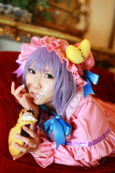 Rule 34 | 1girl, asian, cosplay, couch, cream, crescent, dessert, dress, female focus, food, hat, highres, long hair, patchouli knowledge, photo (medium), purple hair, solo, tenshi myu, touhou