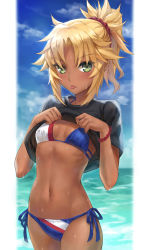 Rule 34 | 1girl, :p, bikini, black shirt, blonde hair, blue bikini, blue sky, blush, braid, breasts, clothes lift, cloud, commentary request, cowboy shot, dark-skinned female, dark skin, day, fate/grand order, fate (series), french braid, highres, looking at viewer, mordred (fate), mordred (fate) (all), mordred (fate/apocrypha), mordred (swimsuit rider) (fate), navel, ocean, outdoors, parted bangs, ponytail, revision, shirt, shirt lift, short hair, short sleeves, side-tie bikini bottom, sky, small breasts, solo, standing, string bikini, swimsuit, tonee, tongue, tongue out, wet