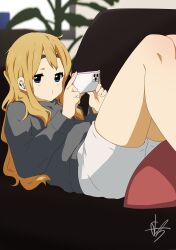 Rule 34 | 1girl, absurdres, blonde hair, blue eyes, casual, cellphone, closed mouth, commentary request, couch, grey shirt, highres, holding, holding phone, indoors, k-on!, kicchi (tmgk), kotobuki tsumugi, long hair, long sleeves, lying, on back, phone, pillow, shirt, shorts, sidelocks, signature, smartphone, solo, thick eyebrows, white shorts, wireless earphones