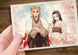 Rule 34 | 1boy, 1girl, 1other, black hair, black pants, blonde hair, blue sky, blush, bright pupils, cape, cherry blossoms, commentary request, crossed arms, dated, eyelashes, fingernails, flame print, forked eyebrows, hakama, hakama pants, hand on own stomach, haori, highres, holding, holding photo, husband and wife, japanese clothes, katana, kimetsu no yaiba, kimono, lips, long sleeves, mismatched eyebrows, multicolored hair, official style, pants, photo (object), pink kimono, pregnant, red eyes, red hair, rengoku ruka, rengoku shinjurou, scabbard, sheath, sidelocks, signature, sky, smile, standing, sword, table, thick eyebrows, tree, twitter username, two-tone hair, weapon, white cape, white pupils, wide sleeves, wooden table, yellow eyes, yuya-art