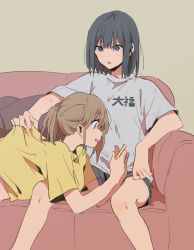 Rule 34 | 2girls, :d, :o, black hair, black shorts, brown hair, clothes pull, clothes writing, couch, cushion, grey background, grey shirt, highres, holding, lying, multiple girls, musshu (omu001), on back, open mouth, original, parted lips, ponytail, shirt, short hair, short shorts, short sleeves, shorts, simple background, sitting, smile, spread legs, t-shirt, yellow shirt