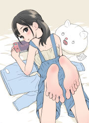 Rule 34 | 1girl, animal-shaped pillow, barefoot, black eyes, black hair, blush, candy wrapper, fanged bangs, feet, flat color, foot focus, from behind, hanamizawa q-tarou, handheld game console, highres, looking back, lying, on bed, on stomach, original, overall shorts, overalls, paid reward available, pants, parted bangs, parted lips, playing games, soles, solo, toes, twintails, unworn pants