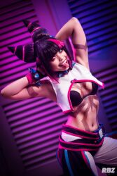 Rule 34 | 1girl, absurdres, arms behind head, black hair, bracelet, breasts, capcom, cosplay, han juri, heterochromia, highres, jewelry, photo (medium), real life, sleinyeswownc, small breasts, smile, solo, spiked bracelet, spikes, street fighter, street fighter 6, tongue, tongue out