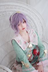 Rule 34 | 1girl, actress request, aqua shirt, center frills, closed mouth, cosplay, cosplay photo, expressionless, floral print, frilled sleeves, frills, hairband, heart, highres, komeiji satori, lips, long sleeves, looking away, looking to the side, photo (medium), pink skirt, print skirt, purple eyes, purple hair, shirt, short hair, sitting, skirt, solo, third eye, touhou, wicker furniture, wig