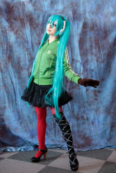 Rule 34 | 1girl, aqua hair, cosplay, cosplay photo, gloves, hatsune miku, headset, jacket, layered skirt, long hair, matryoshka (vocaloid), pantyhose, patterned legwear, photo (medium), red thighhighs, skirt, solo, standing, thighhighs, twintails, very long hair, vocaloid