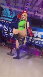 Rule 34 | 1girl, animated, argentine (nationality), ass, bare legs, bare shoulders, blonde hair, braid, cammy white, cammy white (cosplay), capcom, cosplay, curvy, fighting stance, gloves, green leotard, hand on own hip, hat, highleg, highleg leotard, highres, leotard, lips, long hair, looking at viewer, looking to the side, lowres, one eye closed, photo (medium), real life, salute, shiny clothes, simple background, solo, sophie valentine, sound, standing, street fighter, street fighter v, thong leotard, twin braids, twitter username, very long hair, video, wide hips, wink