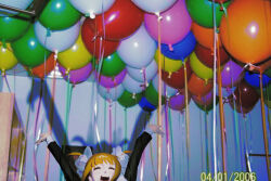Rule 34 | 1girl, arms up, balloon, black dress, blonde hair, choicue, closed eyes, commentary, dress, facing viewer, flesh blood &amp; concrete, hair ornament, hair scrunchie, highres, indoors, jpeg artifacts, light blush, long sleeves, nika (flesh blood &amp; concrete), open mouth, photo background, scrunchie, shadow, sleeve cuffs, smile, solo, timestamp, too many, two side up, wide shot