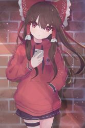 Rule 34 | 1girl, alternate costume, black skirt, bow, brick wall, brown hair, closed mouth, commentary, contemporary, hair bow, hair tubes, hakurei reimu, hand in pocket, highres, holding, holding phone, hood, hoodie, long hair, long sleeves, looking at viewer, matcha yado, phone, red bow, red eyes, red hoodie, sidelocks, skirt, solo, standing, touhou, yin yang, yin yang print