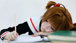 Rule 34 | brown hair, cardcaptor sakura, cosplay, green eyes, highres, kinomoto sakura, magical girl, paper, pencil, photo (medium), school uniform