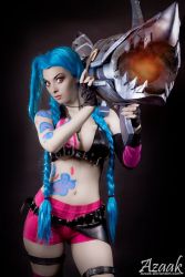 Rule 34 | 1girl, belt, blue hair, bra, breasts, cleavage, cosplay, gloves, jinx (league of legends), league of legends, long hair, looking at viewer, shorts, tattoo, twintails, underwear, weapon